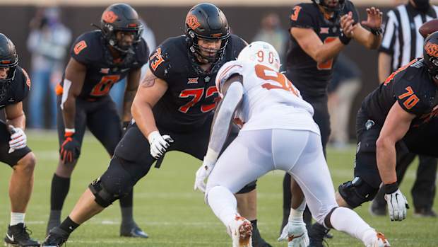 Oct 31, 2020; Stillwater, Oklahoma, USA; Oklahoma State Cowboys offensive lineman Teven Jenkins (73) blocks Texas Longhorns defensive lineman Moro Ojomo (98) during the fourth quarter at Boone Pickens Stadium. Mandatory Credit: Texas won 41-34. Brett Rojo-USA TODAY Sports